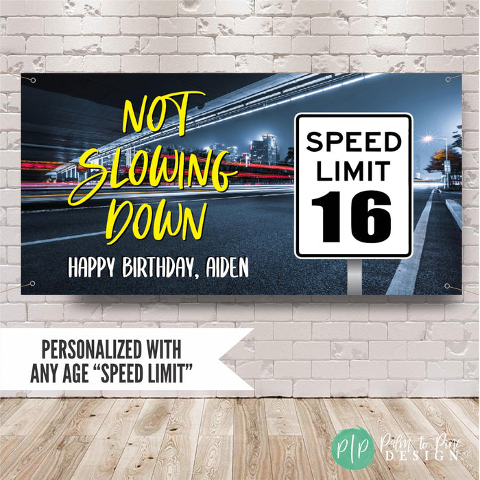 Personalized 16th birthday banner for boys featuring “Not Slowing Down” text, custom name, and a speed limit 16 road sign over a neon city highway background.