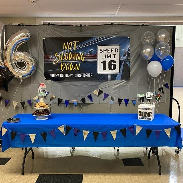 Birthday banner for boys turning 16, featuring a speed limit sign labeled 16, a driver's license motif, 'Not Slowing Down' wording, and space for a personalized message