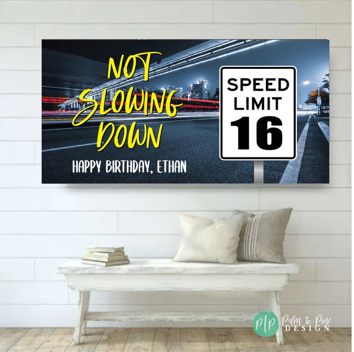 Boys' 16th birthday banner featuring a driver's license and a speed limit sign with the number 16, text reads 'Not Slowing Down' and includes a personalized birthday message.