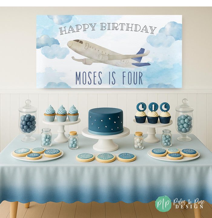 airplane birthday party with personalized banner and blue themed dessert table
