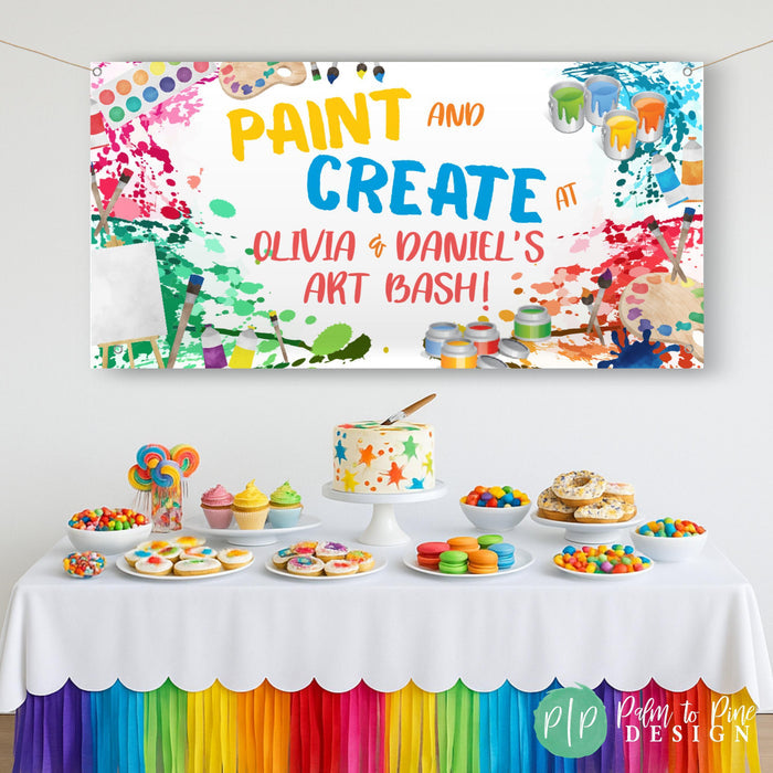 Paint party celebration with an art themed birthday banner hanging behind a colorful dessert table