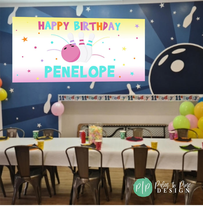 Bowling birthday banner hanging at a party in a bowling ally party room for a bowling-themed celebration.
