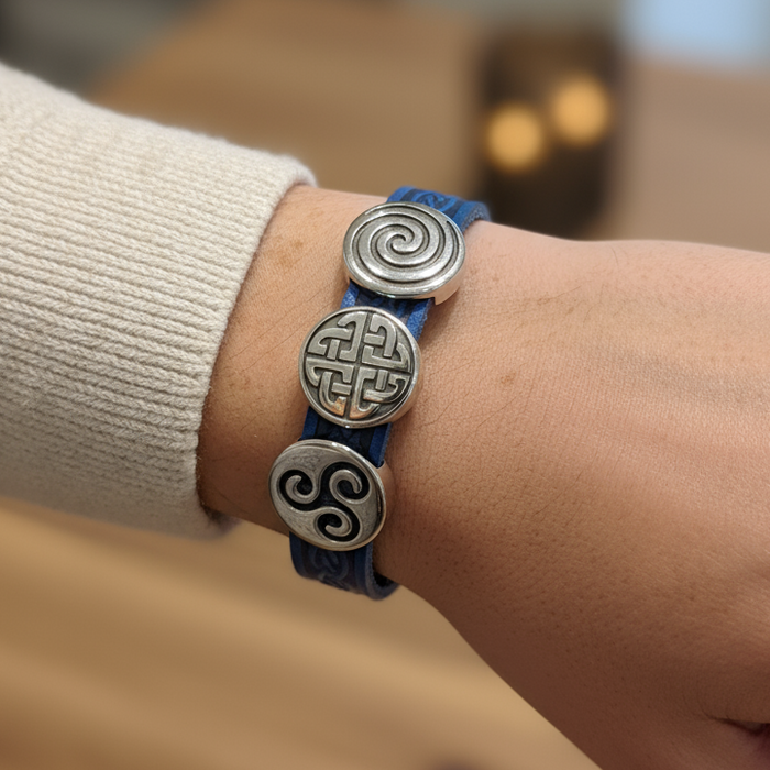 Bracelet with Celtic knot designs on a wrist.