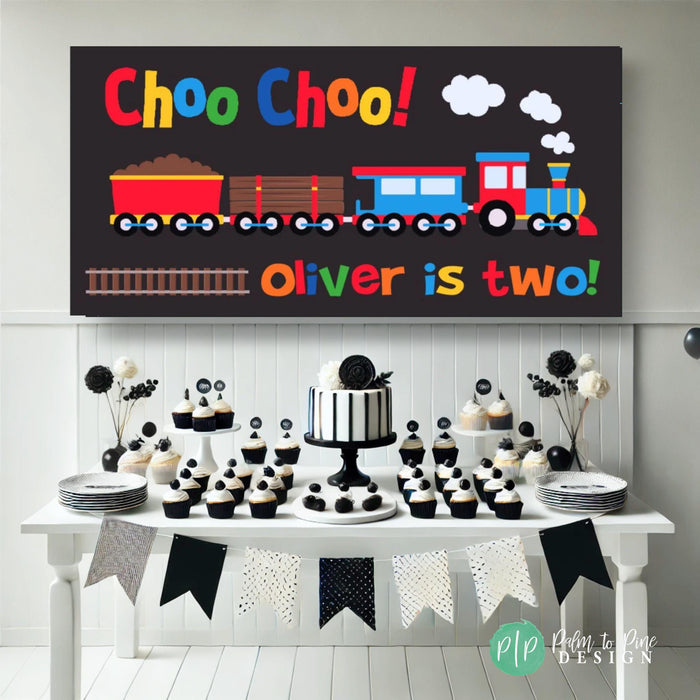 black, white and primary color train birthday party with personalized banner and dessert table