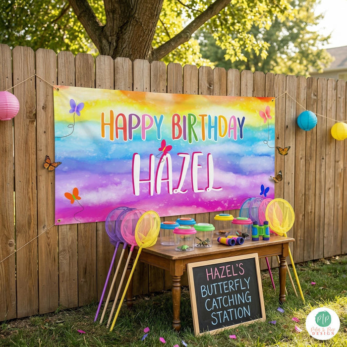 Bright butterfly birthday banner displayed at backyard birthday party with butterfly catching activity station