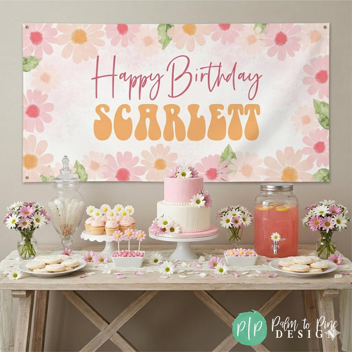 Daisy birthday party with personalized banner and pink and white wild flower dessert table