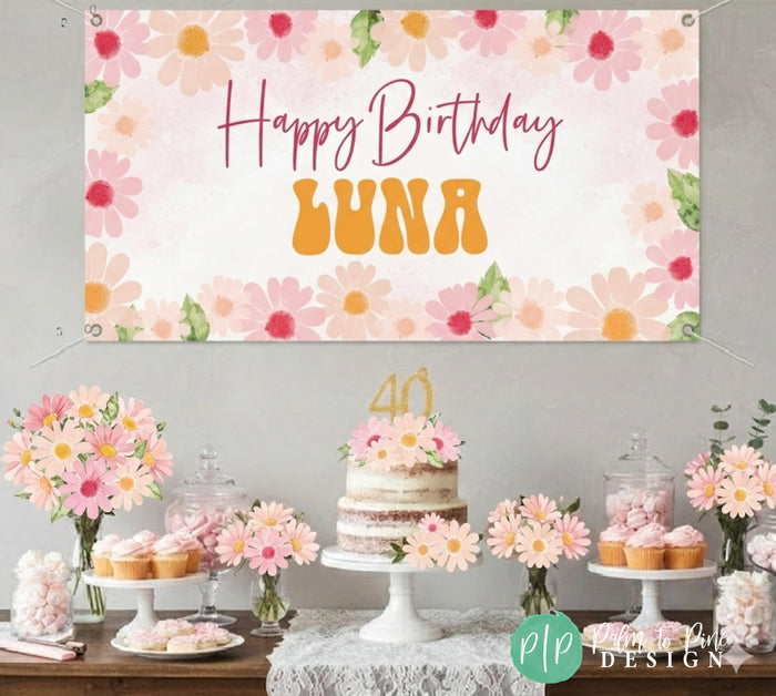 daisy birthday banner hung behind wildflower dessert table