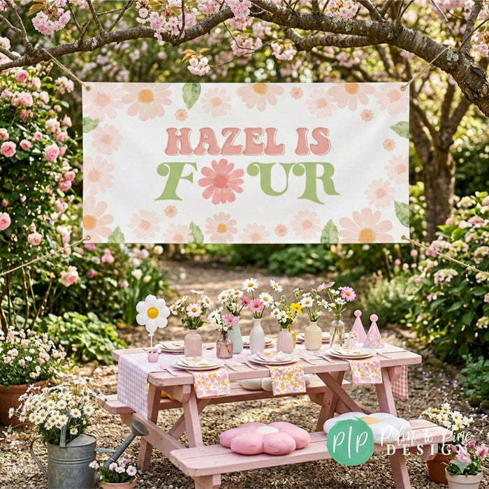 Girls daisy garden party with personalized banner hung outdoors above a picnic table set with wildflowers and daisy decorations