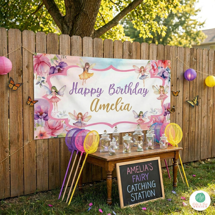 personalized Fairy party banner displayed outdoors for a garden birthday celebration with a fairy catching station