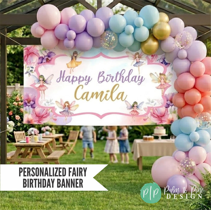 Fairy birthday banner styled with large balloon garland in blush pink, light purple, blue and gold decorations at outdoor garden party