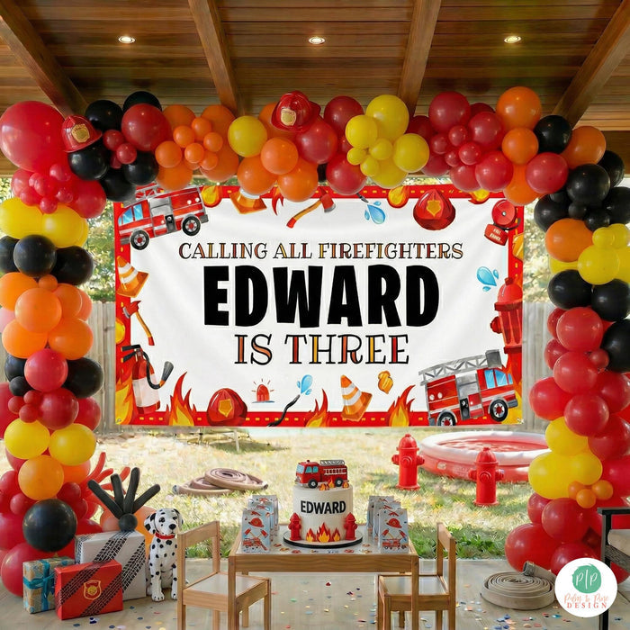 Kids outdoor firefighter birthday party with custom banner decorations and balloon garland