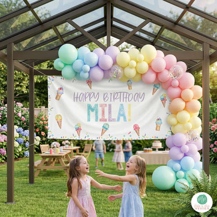 Girls ice cream sprinkles outdoor birthday party with personalized banner and balloon garland