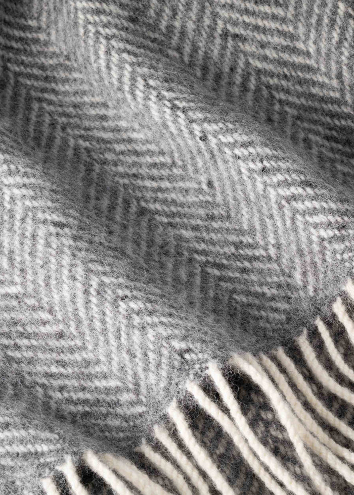 Close-up of a textured fabric with a herringbone pattern