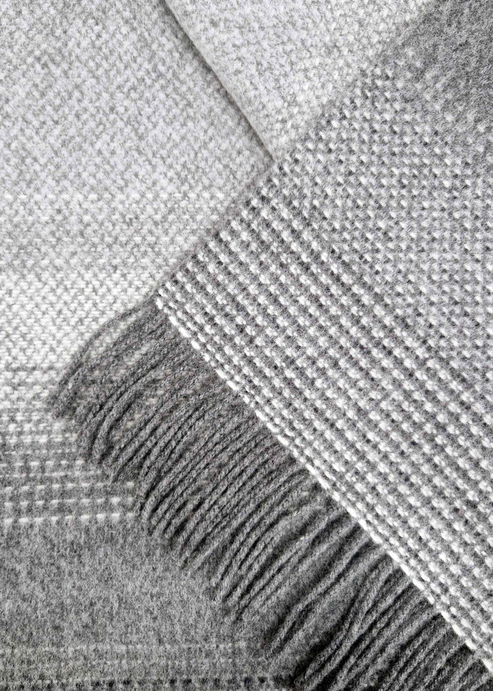 Close-up of a textured gray fabric with fringes