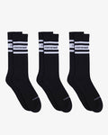A 3-pack of Les Socks in black, laid flat side-by-side on a white background. The image features the white c'est normal logo positioned between two white stripes on the calf of each sock.