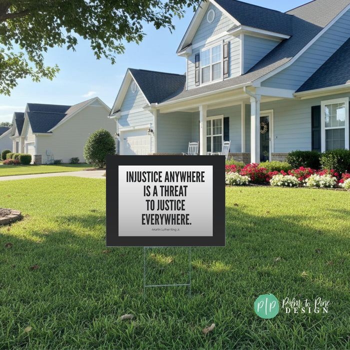 a social justice lawn sign with a MLK quote about human rights and a house in the background.