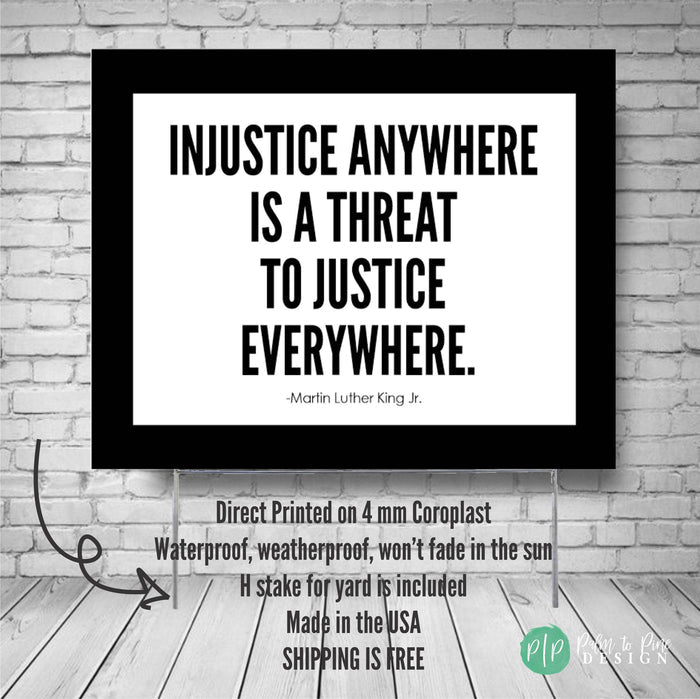 a social justice yard sign featuring a quote by Martin Luther King Jr. against a brick wall background.