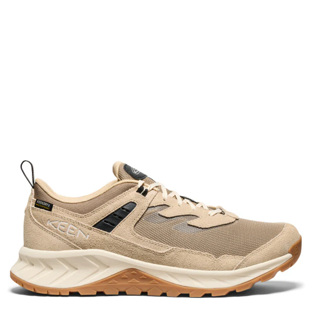 A single KEEN brand midfoot hiking shoe in a warm beige and tan colorway, featuring a textured mesh and suede upper, beige laces, a thick cream midsole, and a gum brown outsole, shown against a plain white background.