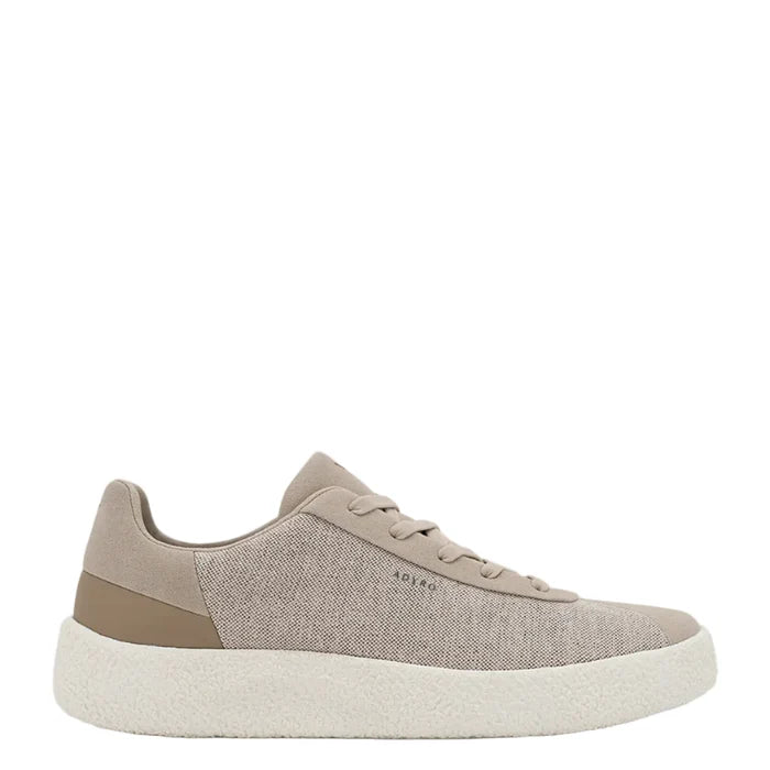 Beige sneaker with a white sole on a light beige background