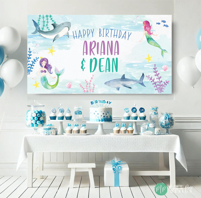 personalized under the sea birthday banner for kids with a watercolor blue background and mermaid, shark and coral clipart