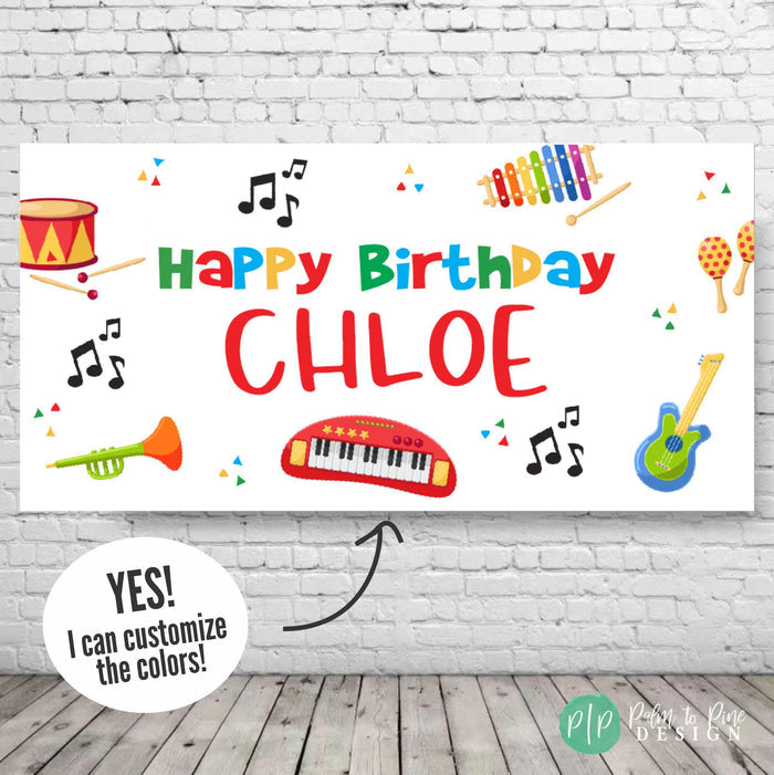 Colorful musical birthday banner for kids, decorated with rainbow-themed instruments and music notes