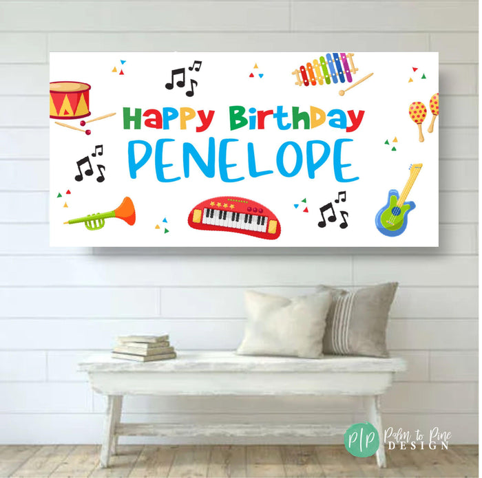 musical birthday banner for kids featuring rainbow colors on a white background with musical instruments and notes