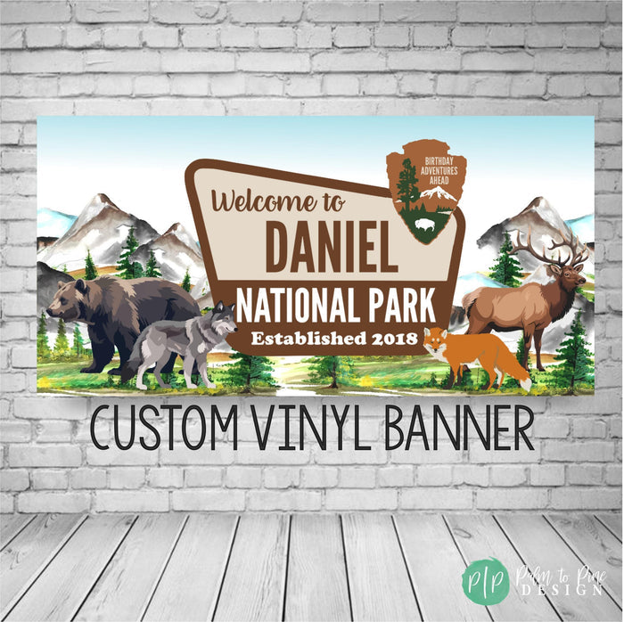 National park themed birthday banner at outdoor adventure party