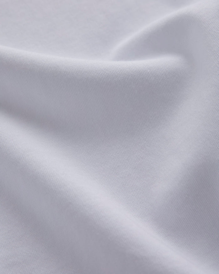 A close-up shot of the soft, thick premium cotton fabric of the Oversized Tonal T-Shirt in white, highlighting its texture and high quality.