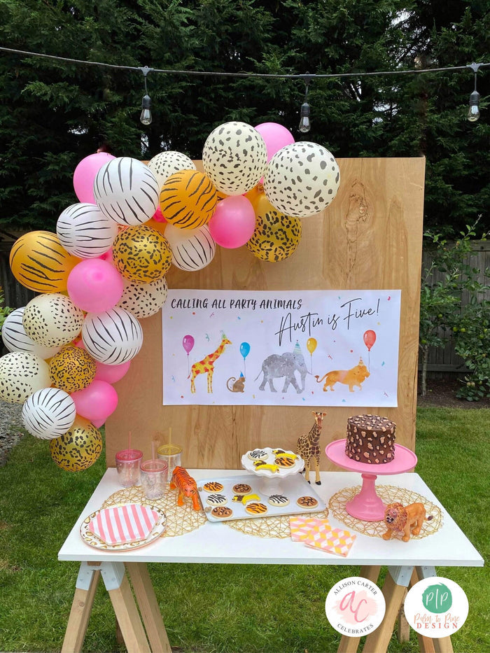 Personalized jungle party banner featuring lion, giraffe, zebra, and monkey illustrations for a first birthday or animal-themed celebration