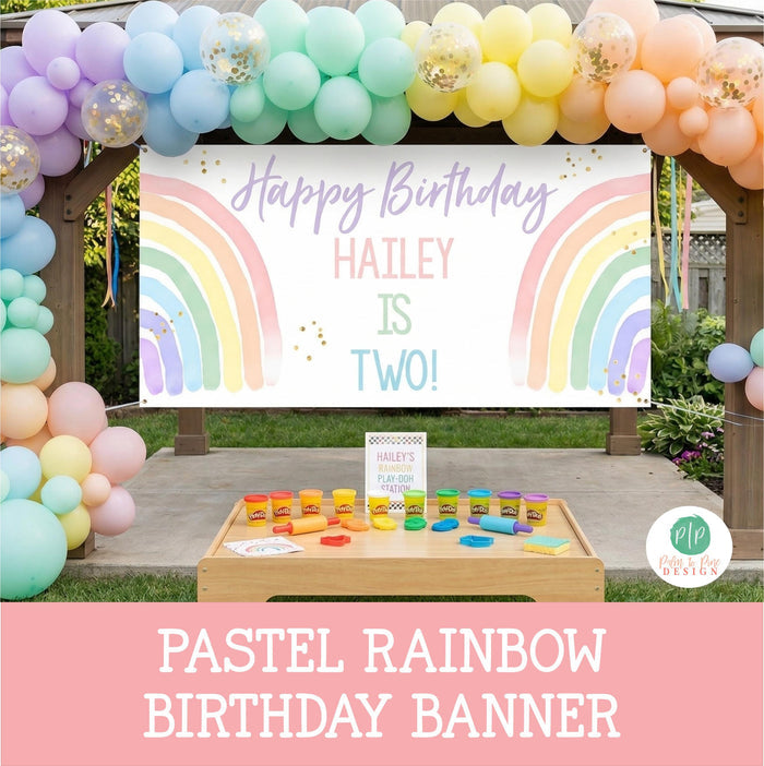 Girls rainbow themed birthday party in pastel colors set in backyard with balloon garland, personalized banner and play doh activity table
