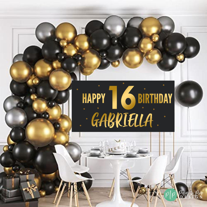 black and gold birthday banner with balloon arch