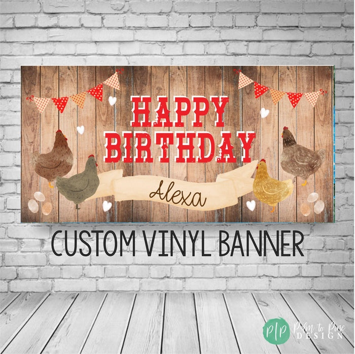 A custom vinyl banner for a birthday celebration, featuring a rustic wooden background with chicken illustrations and red and white polka dot flags.
