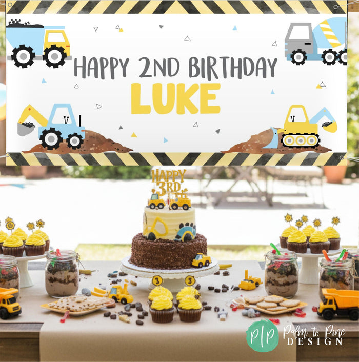 Boys construction birthday party with themed cake and desserts and personalized banner hanging outdoors