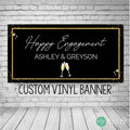 Engagement Banner in black and gold with elegant script font and champagne glasses