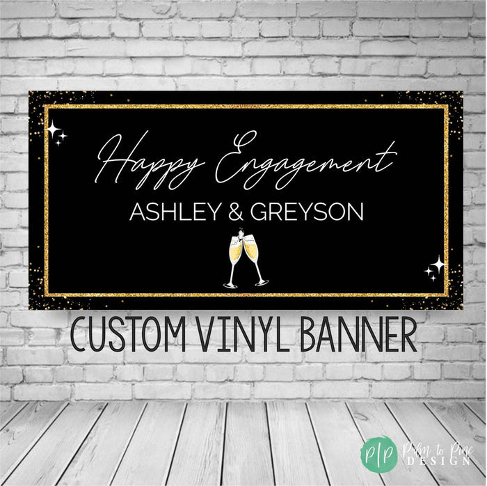 Engagement Banner in black and gold with elegant script font and champagne glasses