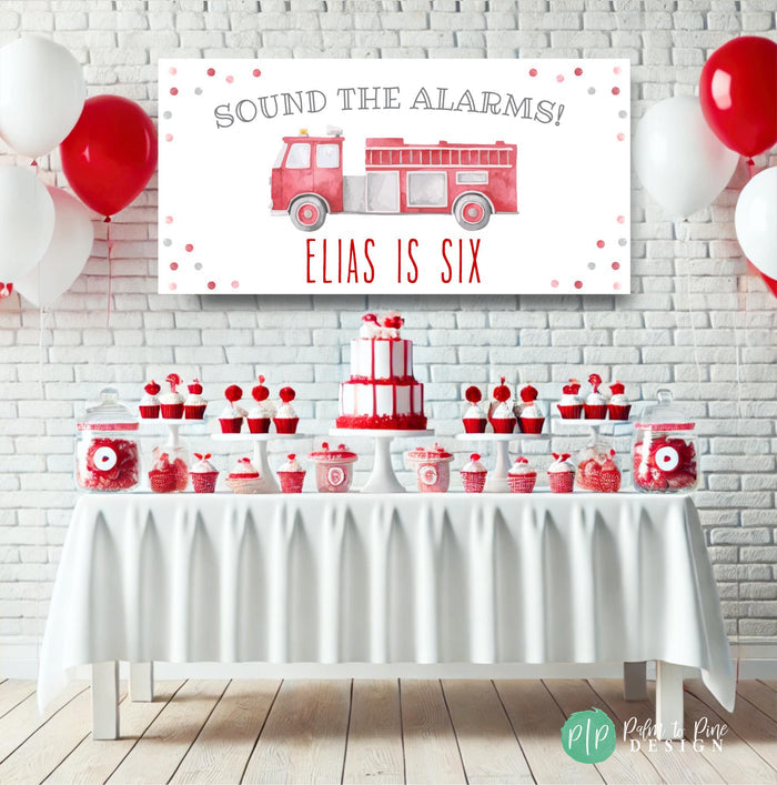 Custom firetruck birthday banner featuring a red watercolor fire engine, “Sound the Alarms” message, and child’s name and age