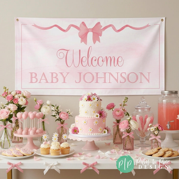Coquette Bow baby shower banner, displayed behind pink and white dessert table at party