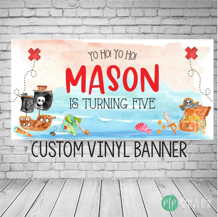 pirate birthday banner with watercolor beach background, pirate ship, jolly roger flag, pirate gold and a treasure map. Font reads Yo Ho Yo Ho, let's celebrate and is personalized with the birthday boys name