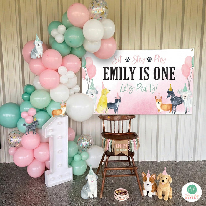 Girls first birthday in pink and mint puppy dog party scheme with personalized banner, balloon garland and high chair