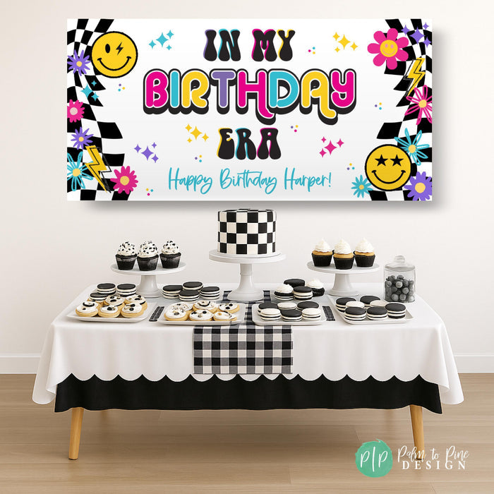 In My Birthday Era personalized girls birthday banner with retro checkered pattern vibe in front of black and white dessert table with checkered pattern theme