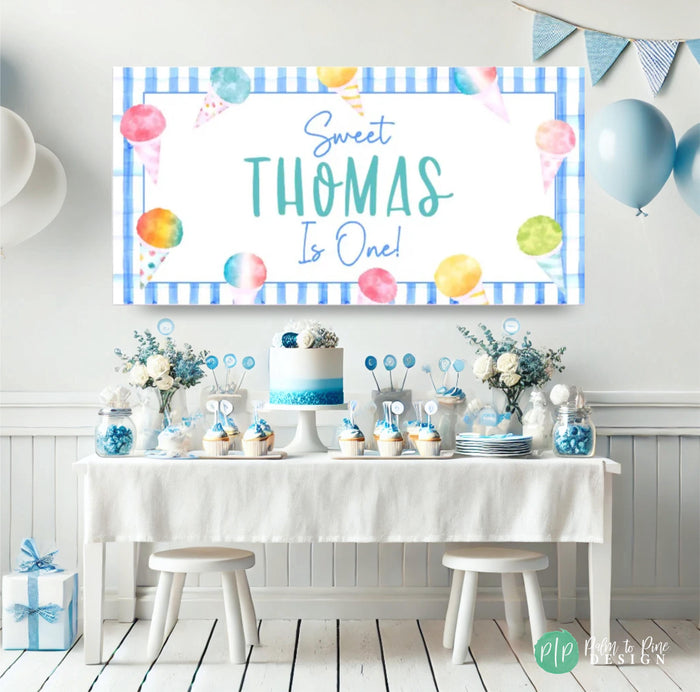Boys Snow Cone Birthday Banner in front of light blue dessert table