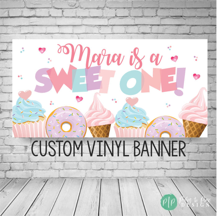 Sweet one birthday banner in pastel color scheme with donuts, cupcakes and ice cream