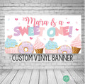 Sweet one birthday banner in pastel color scheme with donuts, cupcakes and ice cream