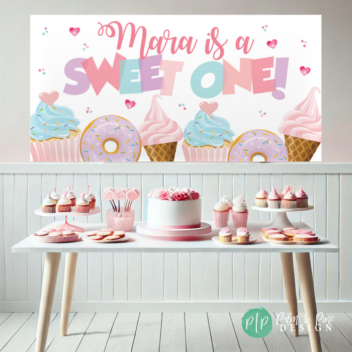 sweet one banner in front of sweets birthday table for girls party