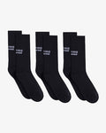 Three pairs of The Athlétique Socks in black, laid flat next to each other on a white background. The image highlights the white c'est normal logo stitched at mid-calf.