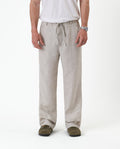 The Holiday Linen Trouser in natural — front view showing the drawstring waist