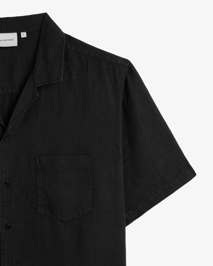 The Holiday Linen SS Shirt in black — close-up of the collar and chest pocket