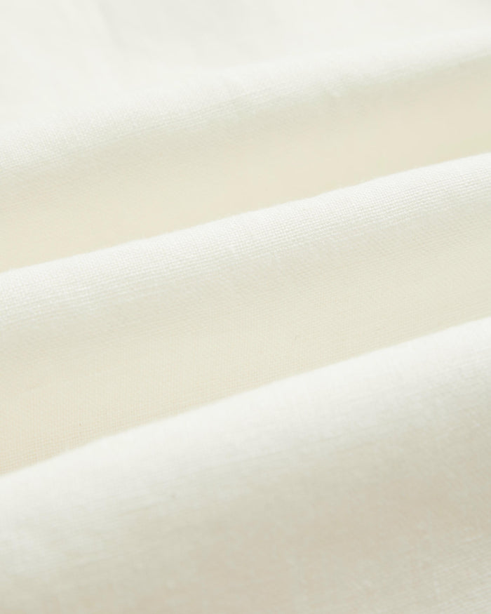 The Holiday Linen SS Shirt in off white — close-up of the breathable linen fabric texture