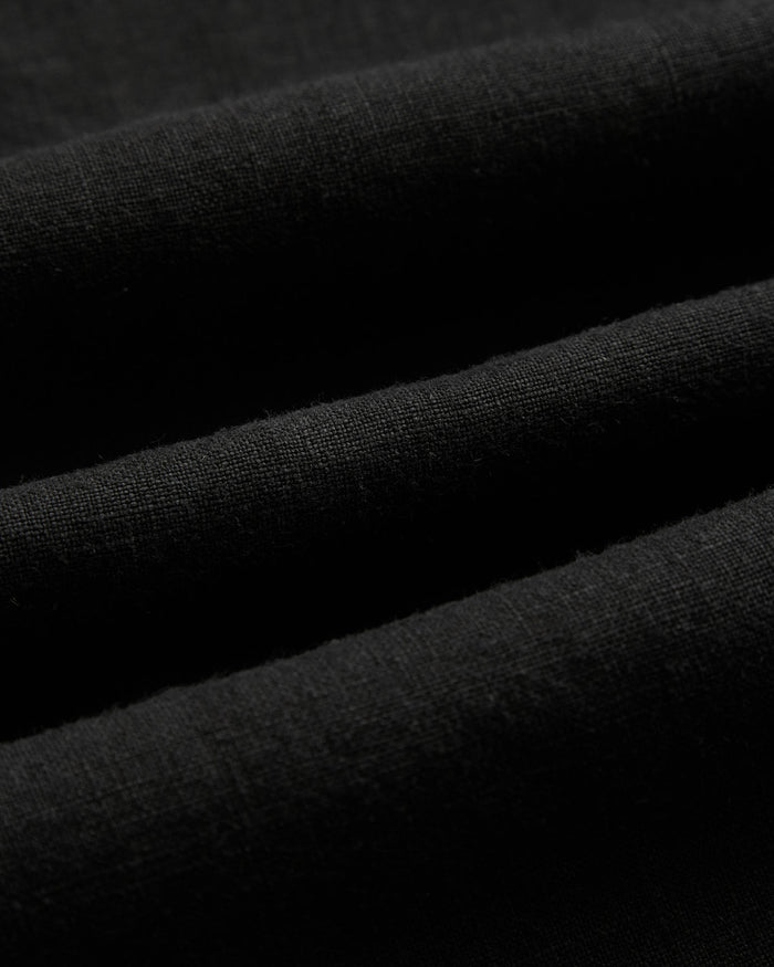 The Holiday Linen SS Shirt in black — close-up showing the breathable linen texture