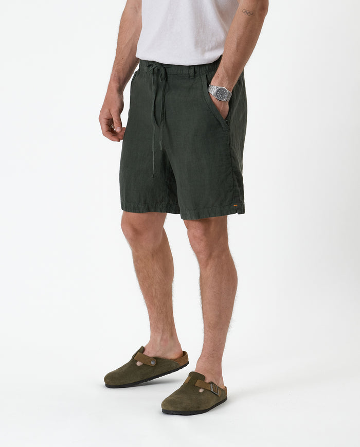 The Holiday Linen Short in dark khaki — side-front view with drawstring waist